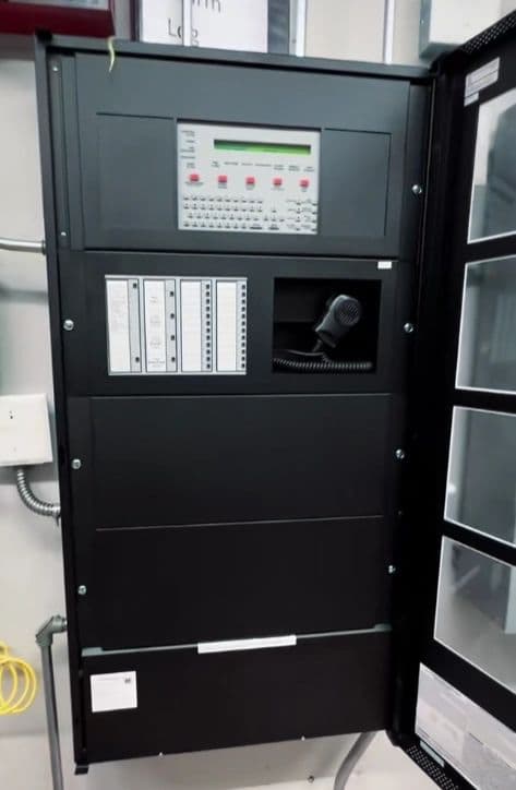 Fire alarm control panel cabinet with an emergency voice microphone